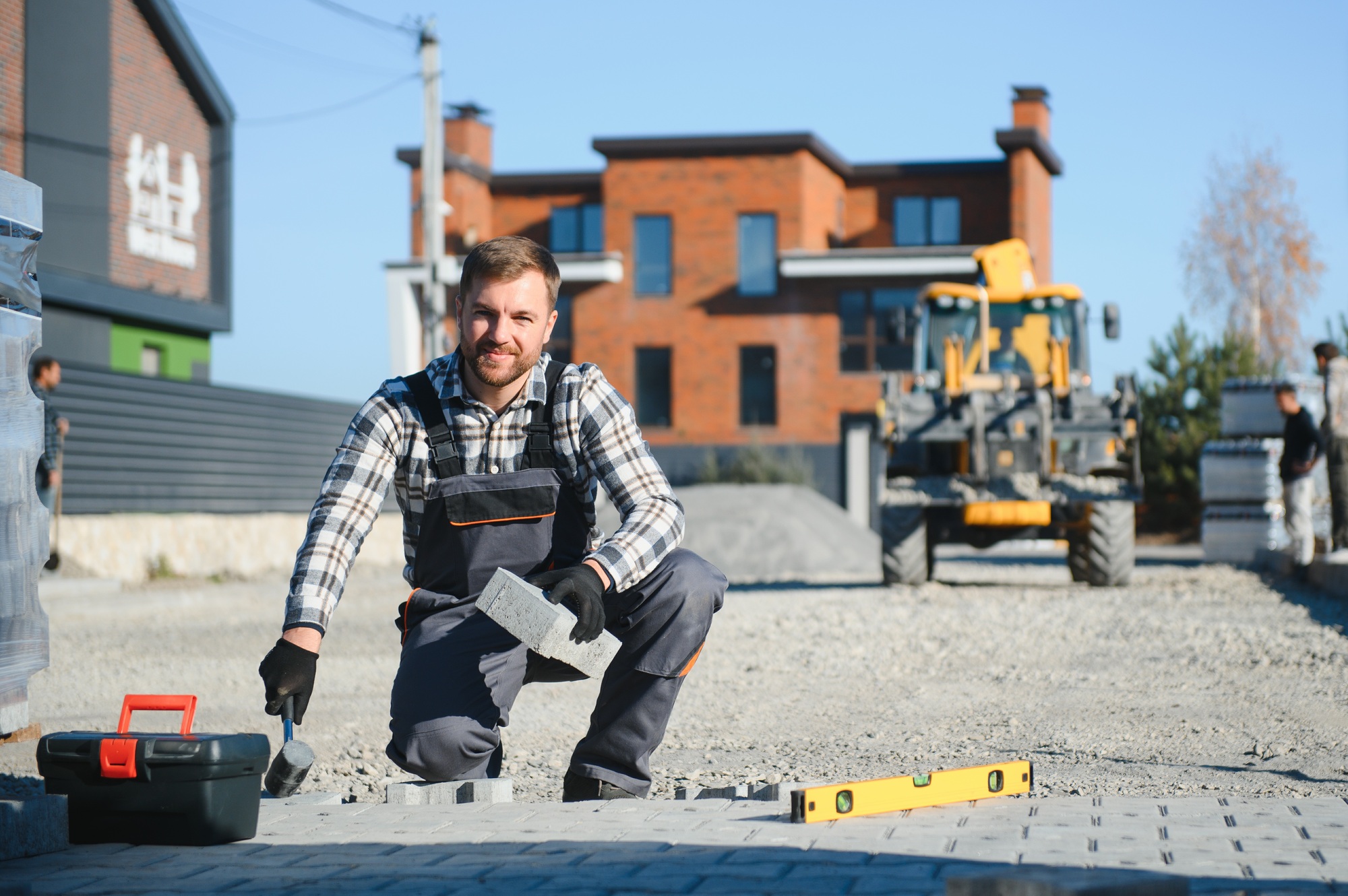 Paver laying driveway pavement out of concrete pavement blocks